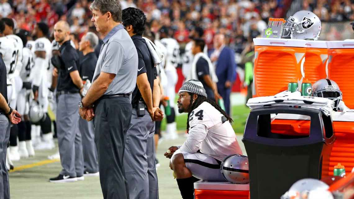 Marshawn Lynch sits during national anthem